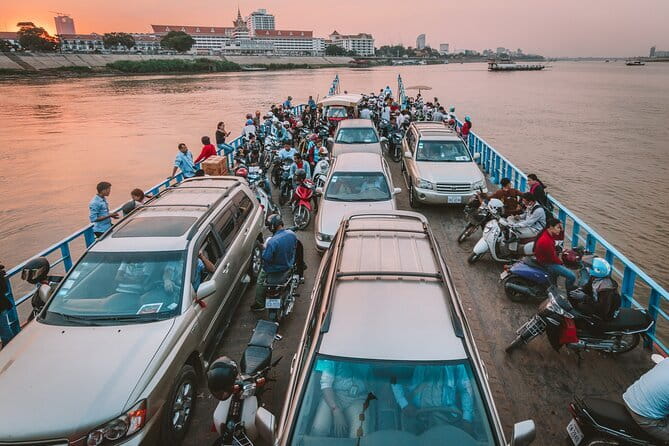 Riverside Walking Tour with Snack, Drinks & Local Ferry Ride - The ferry ride as Phnom Penh changes color
